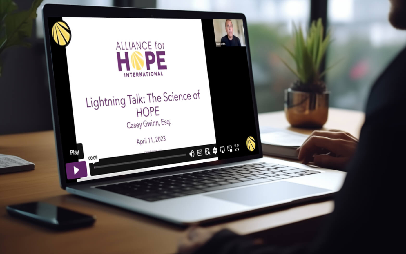 A laptop being used with an Alliance for HOPE webinar being displayed on it