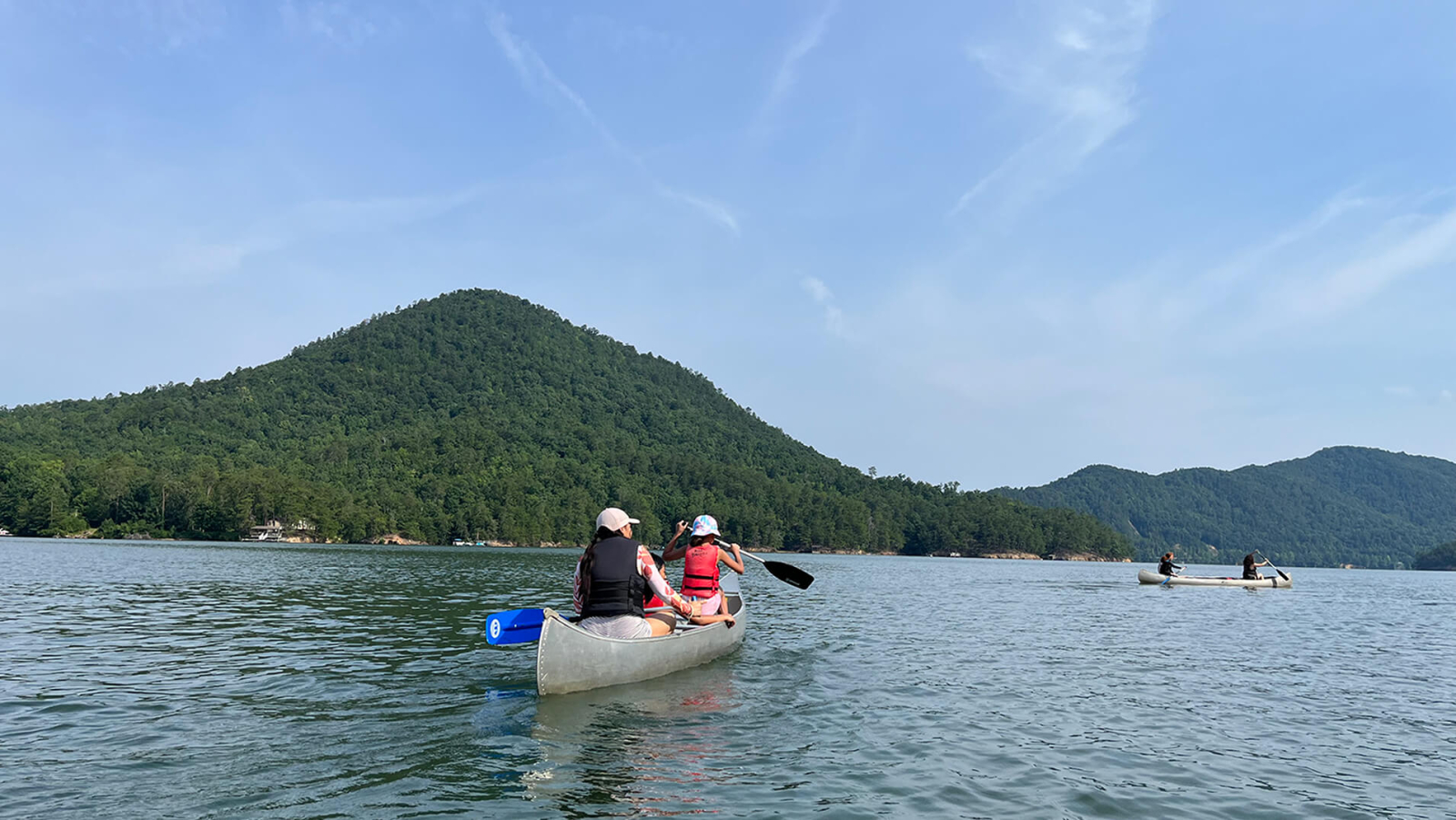 Two girls kayaking on a river