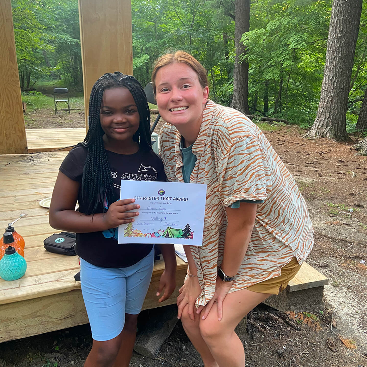 A young girl holding a character trait award