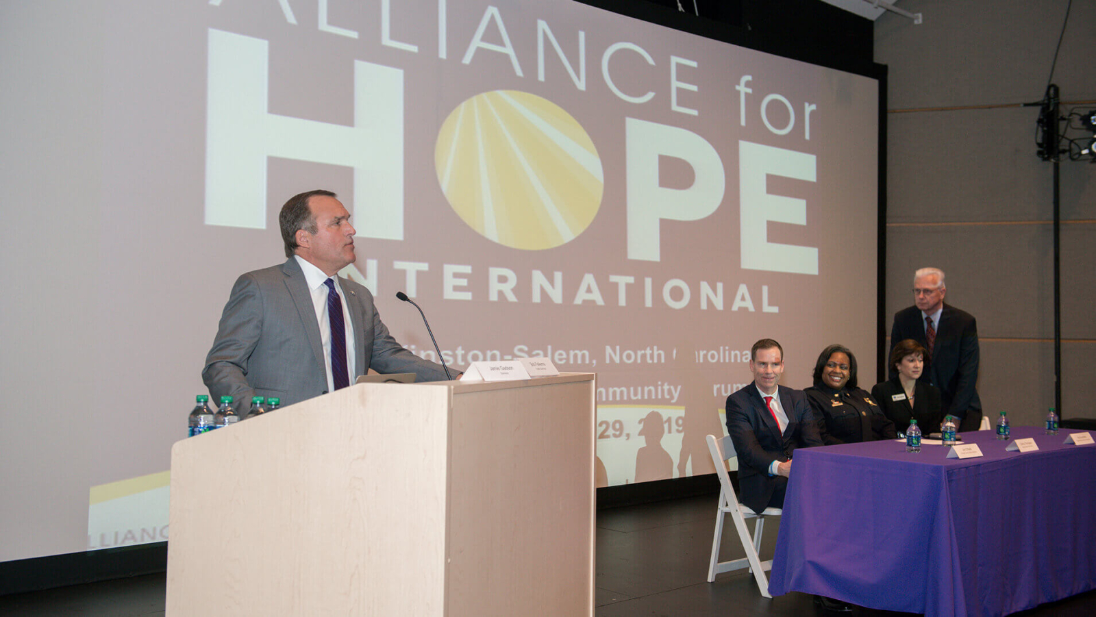 Casey Gwinn of Alliance for HOPE, giving a presentation in a conference room.